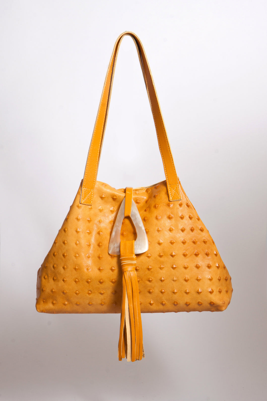 <b>Stacie</b><br> <p><font size=“3px”> Mustard Pyramid Tote With Horn Tassel</font></p>