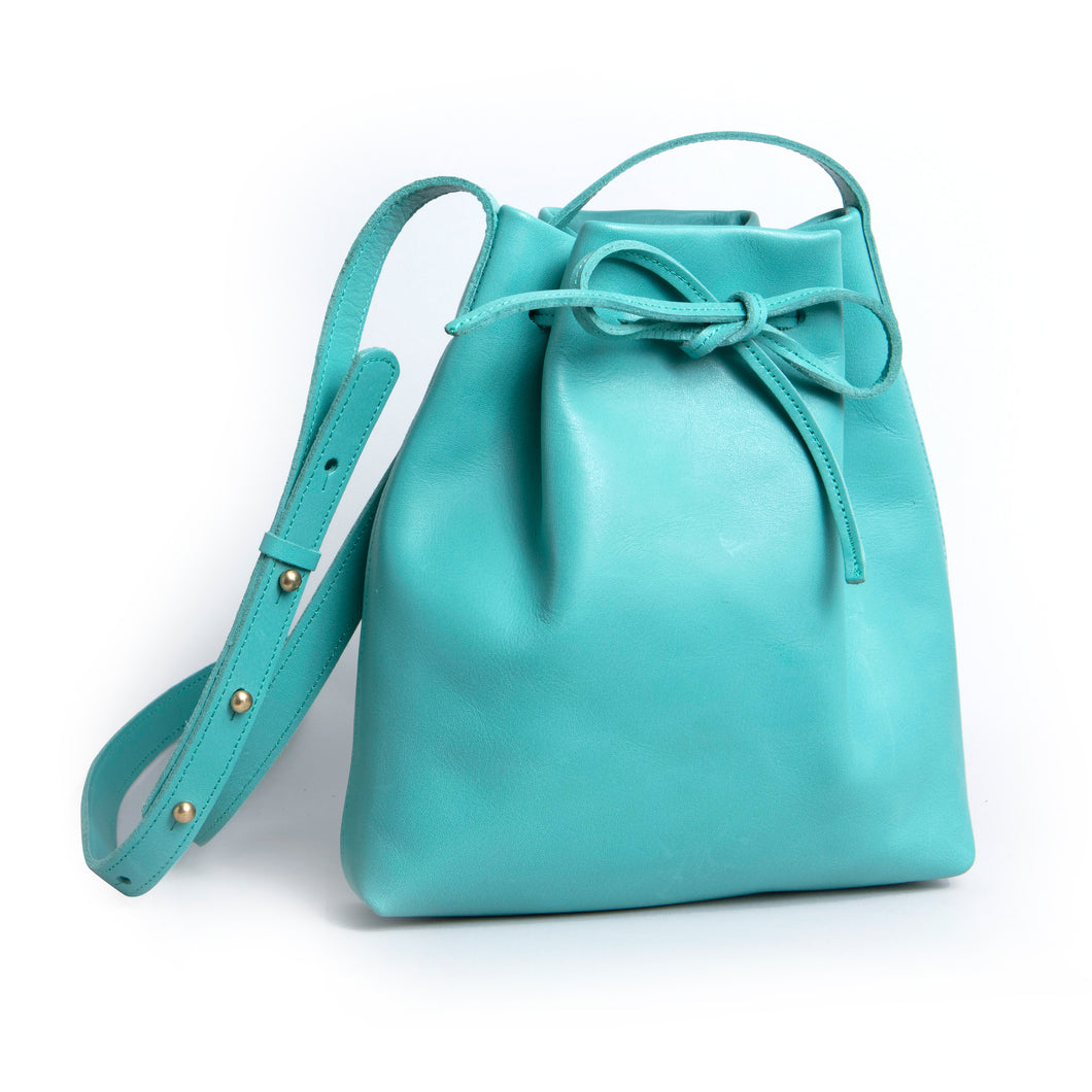 <b>Darlene</b><br> <p><font size=“3px”>Turquoise Leather Drawstring With Bow</font></p>