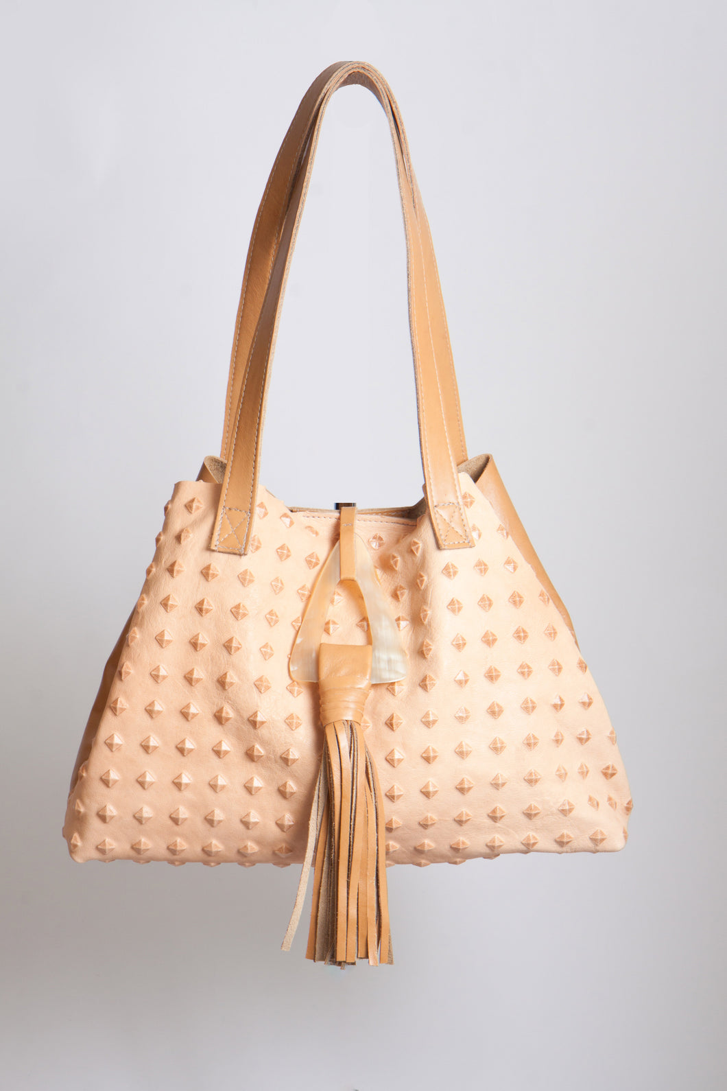 <b>Stacie</b><br> <p><font size=“3px”> Camel Pyramid Tote With Horn Tassel</font></p>